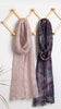 Two scarves, one pink and one multicolored, hanging on a wooden rack against a white background.
