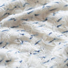 Close-up of textured white fabric with blue thread