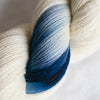 Close-up of a skein of yarn with blue and white colors.