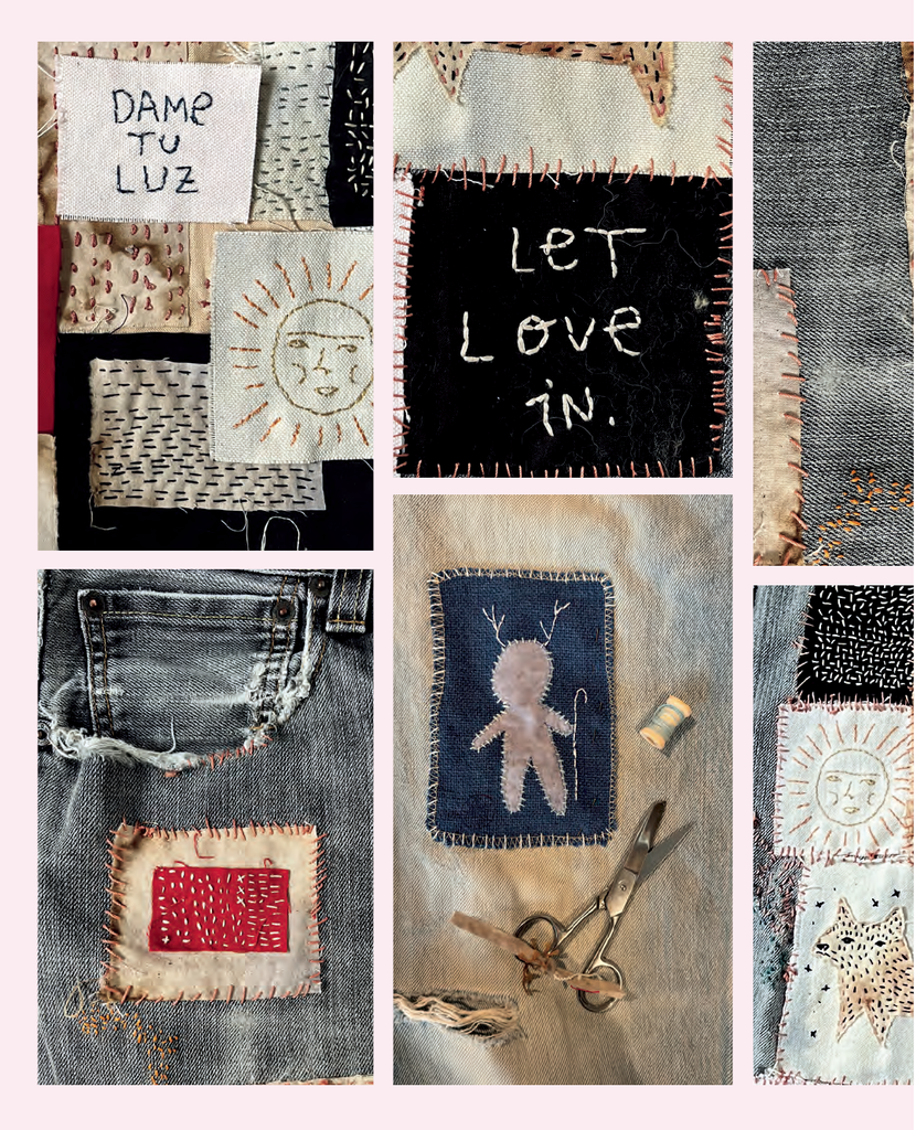 A collage of handmade textile patches and fabric samples with embroidered designs, stitched text, denim, and small sewing tools on a pale pink background.