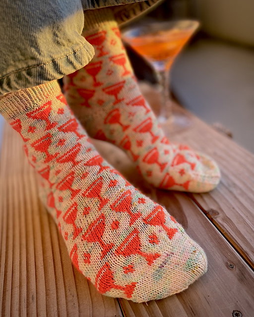 Person wearing patterned socks on a wooden surface with a blurred background