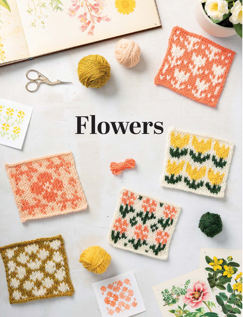A styled flat-lay of knitted floral swatches arranged on a white surface with yarn balls, scissors, an open floral book, and small flower cards. The central text reads “Flowers.