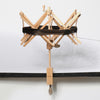 wooden umbrella swift with a hank of yarn on it.