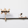Wooden umbrella swift and ball winder winding a skein of yarn.