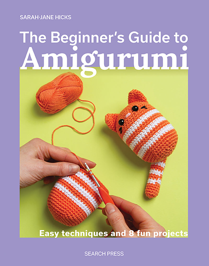 Book cover of 'The Beginner's Guide to Amigurumi' with a purple border and amigurumi toy on a green background.