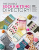 Front cover of the book 'The Doodle Sock Knitting Directory' by Jamie Lomax, featuring multiple knitted socks in colorful patterns arranged on a light background with yarn balls, knitting needles, and pattern cards.