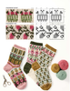 Knitted socks with floral and geometric patterns displayed alongside color swatches, knitting pattern charts, scissors, and balls of yarn on a white background.