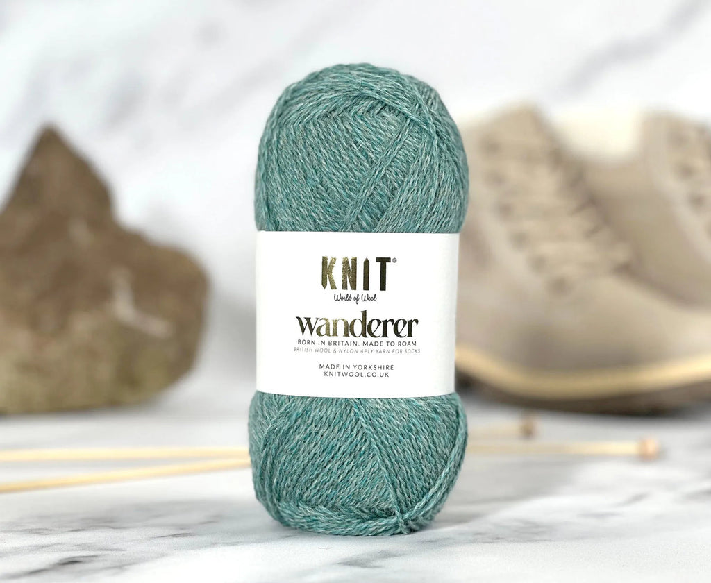 Teal skein of yarn with 'Knit Wanderer' label on a white background