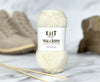 Ball of yarn with 'Knit Wanderer' label on a marble surface