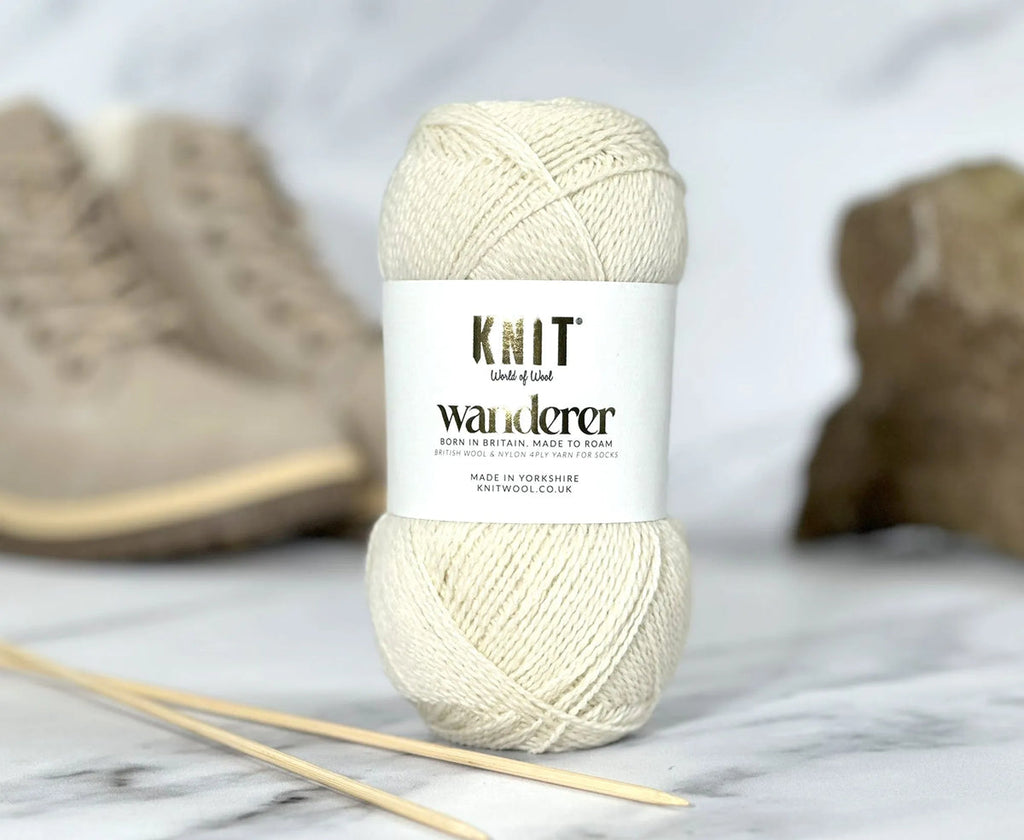 Ball of yarn with 'Knit Wanderer' label on a marble surface