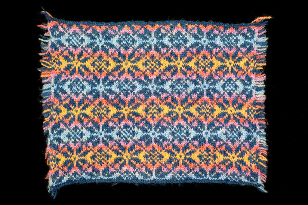 Colorful knitted fabric with geometric pattern on a black background
