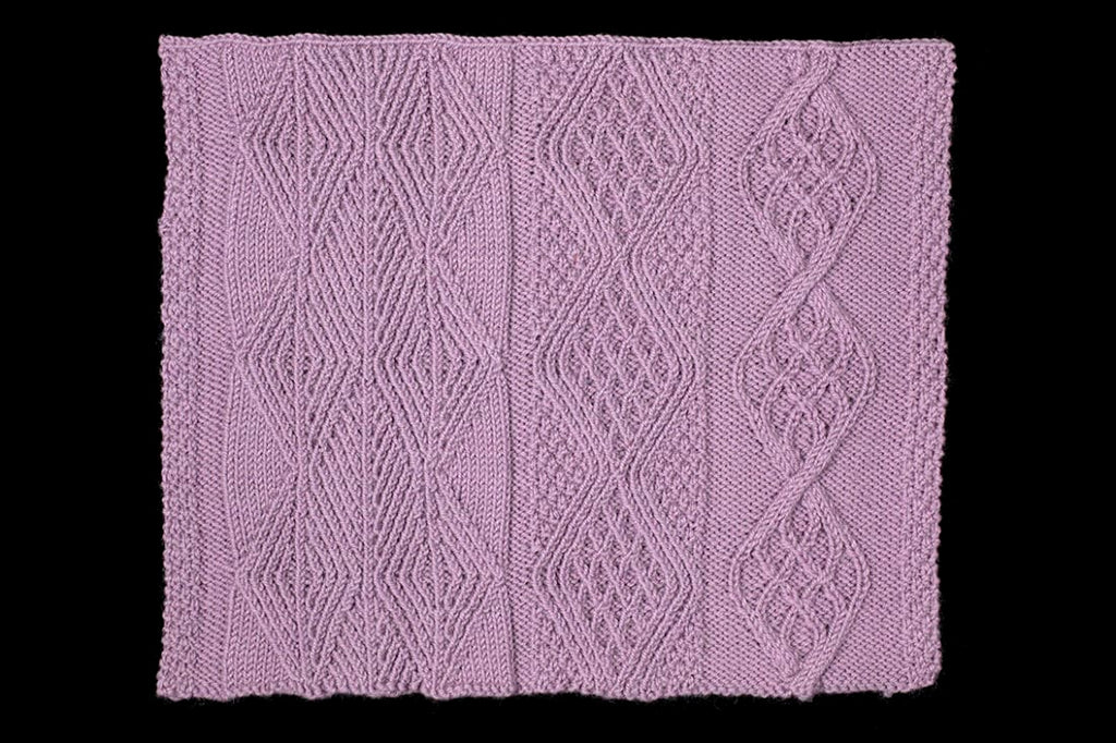 Purple knitted fabric with geometric pattern on a black background