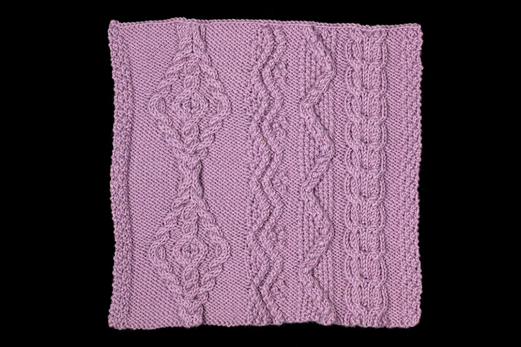 Purple knitted fabric with a decorative pattern on a black background