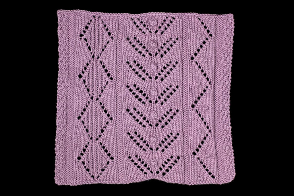 Purple knitted fabric with a geometric pattern on a black background