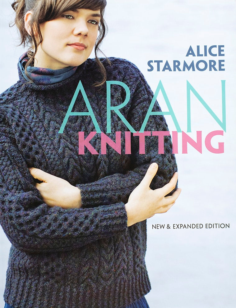Book cover of 'Aran Knitting' by Alice Starmore featuring a person wearing a knitted sweater.