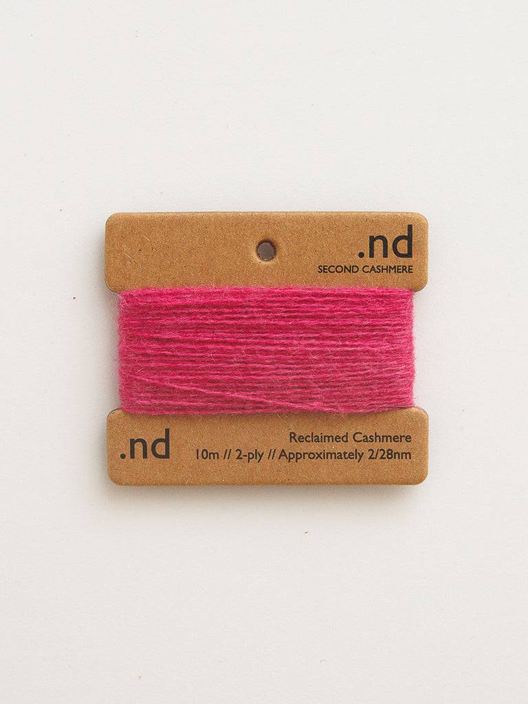 Pink cashmere yarn on a branded card with 'nd' on a white background