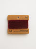 Red cashmere yarn on a branded card with 'nd' logo on a white background