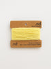 Yellow yarn on a brown card with 'nd' branding on a white background