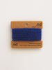Blue yarn on a brown card with 'nd' branding on a white background