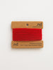 Red yarn on a brown card with 'nd' branding on a white background