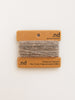 Card with brown and gray yarn swatch on a beige background