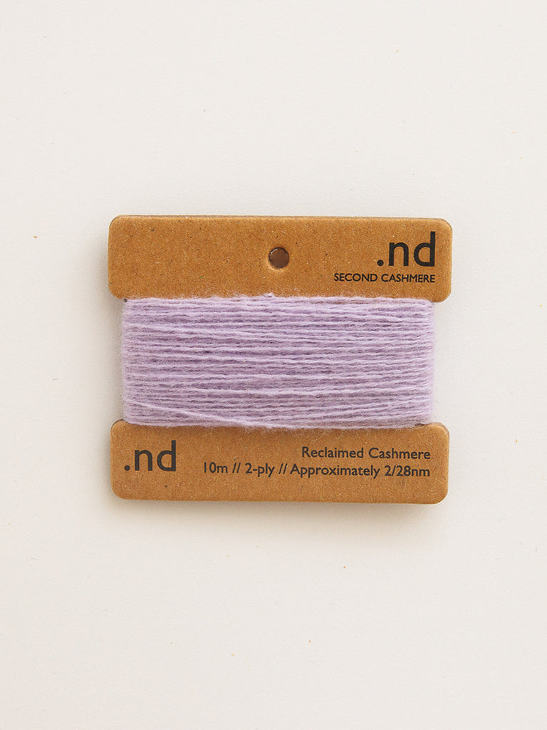 Card with purple yarn swatch and 'nd' branding on a beige background