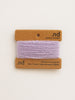 Card with purple yarn swatch and 'nd' branding on a beige background