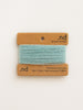 Teal yarn on a cardboard holder with 'nd' branding on a white background