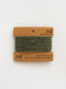 Green yarn on a brown card with 'nd' branding on a white background