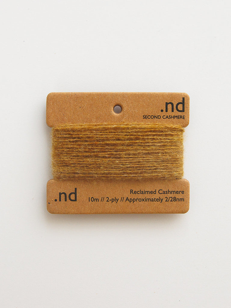 Reclaimed cashmere yarn on a branded card with 'nd' branding on a light background