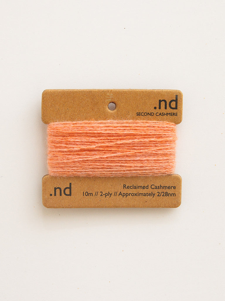 Peach-colored yarn on a brown card with 'nd' branding on a white background