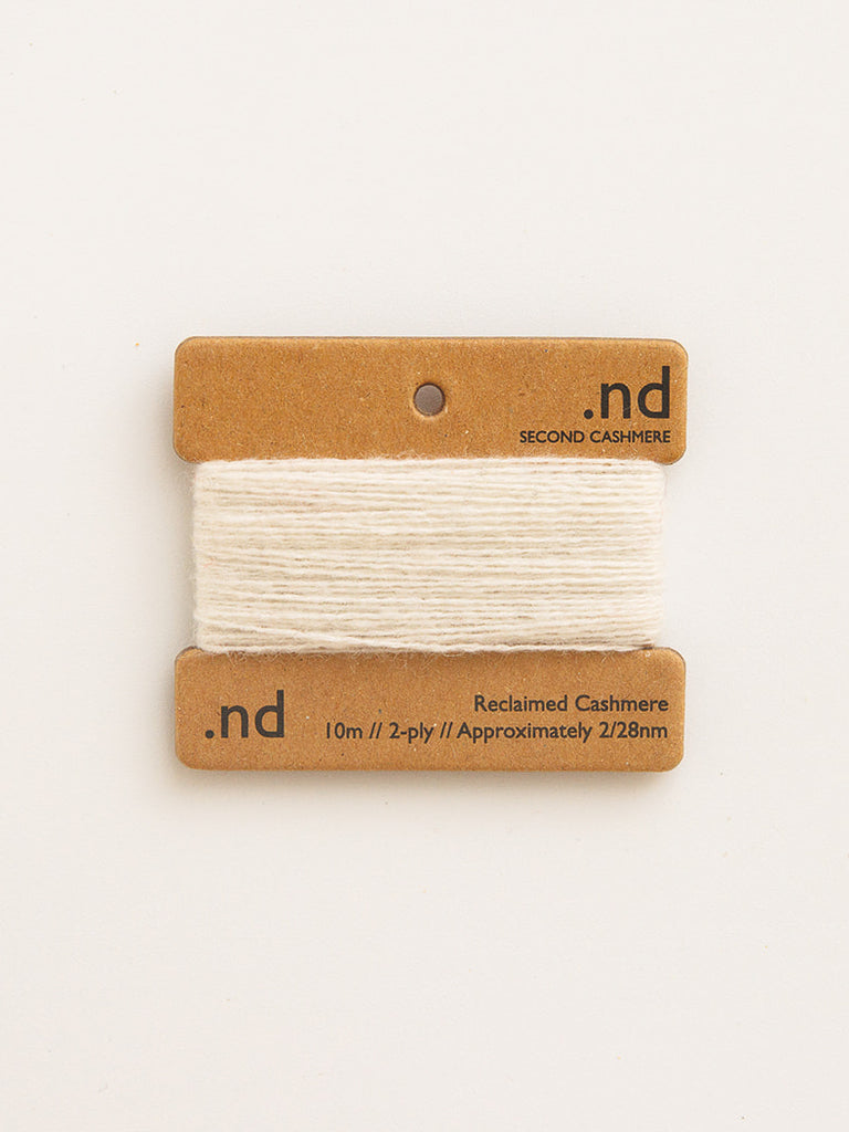 Reclaimed cashmere yarn on a branded card with 'nd' logo on a white background