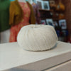 Ball of yarn on a wooden surface with a blurred background