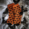 Orange and black patterned socks on a spider web background
