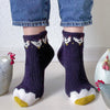 Person wearing dark purple socks with chicken designs on a light background