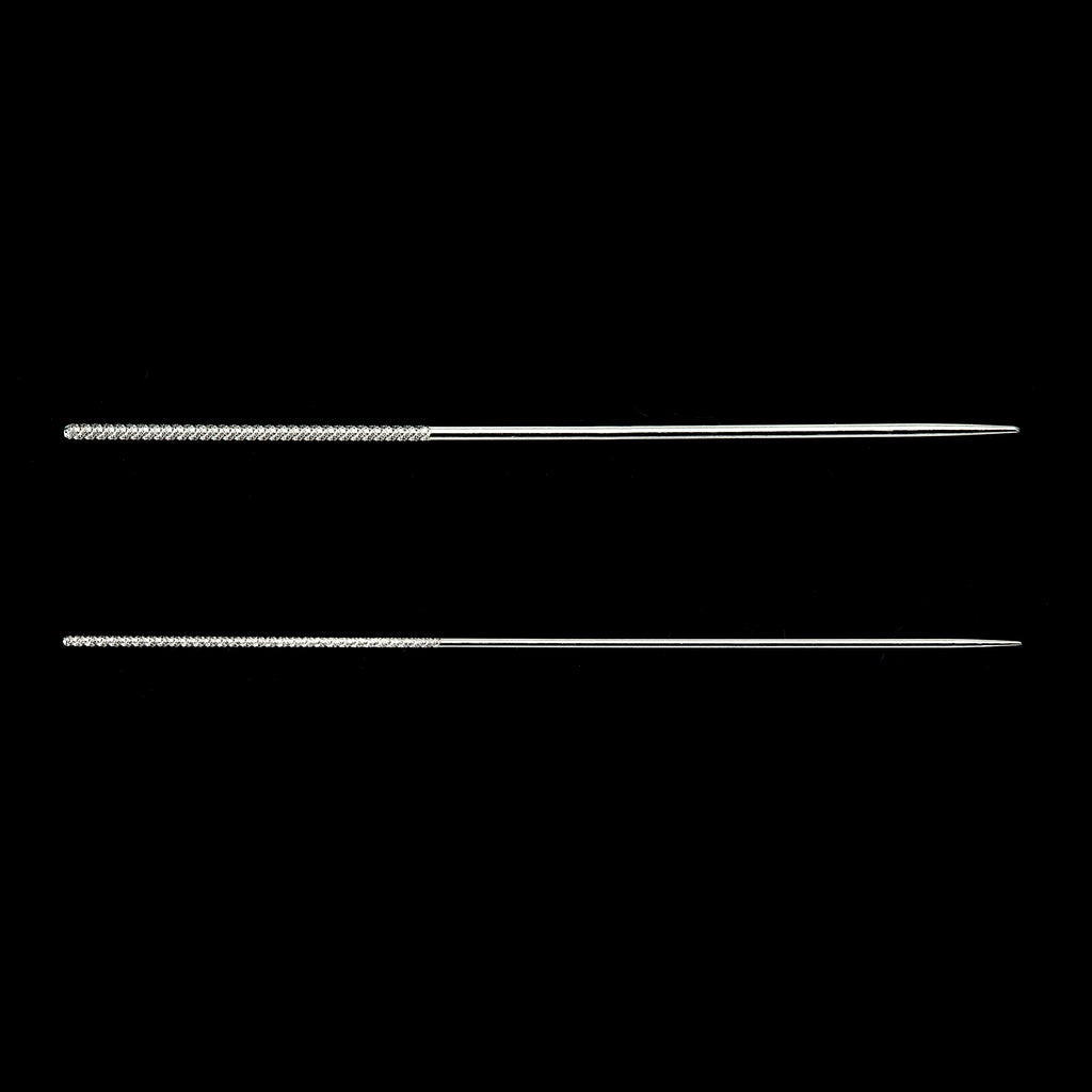 Two silver needles on a black background