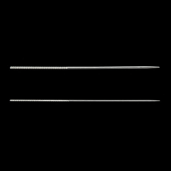 Two silver needles on a black background
