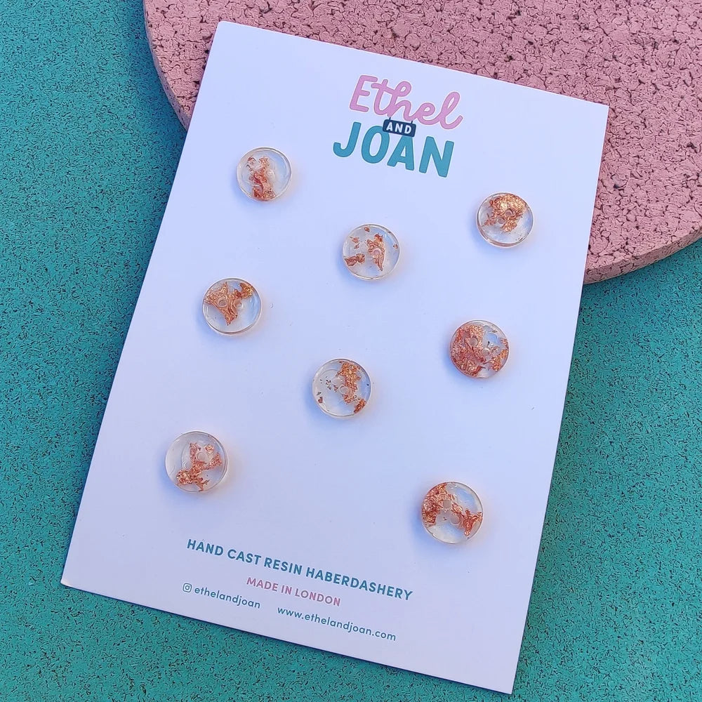 set of clear resin buttons with a copper flake