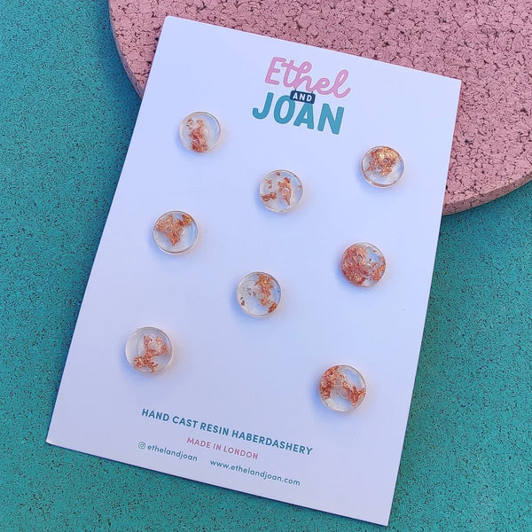 set of clear resin buttons with a copper flake