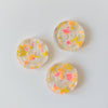 clear resin buttons with pink and orange flecks