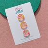 set of 3 resin buttons with orange and pink flecks