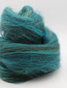 Turquoise blue skein of yarn on a white background