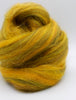 Ball of yellow and green yarn on a white background