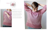 Woman wearing a pink striped sweater with 'Dubarry' branding, displayed against a neutral background.