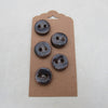 Four dark blue buttons on a cardboard backing against a white background