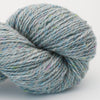 Close-up of a skein of blue and gray yarn on a white background