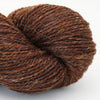Close-up of a skein of brown yarn on a light gray background