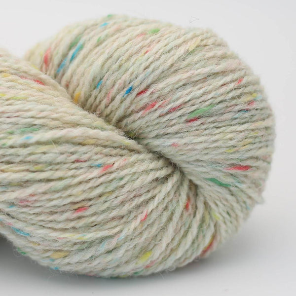 Ball of yarn with multicolored speckles on a white background