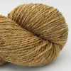 Close-up of a skein of brown yarn on a white background