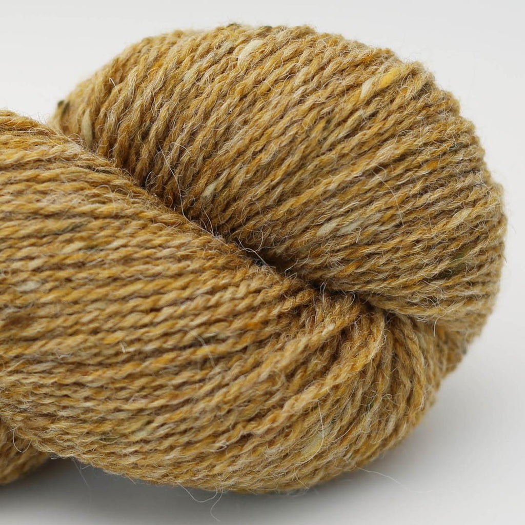 Close-up of a skein of brown yarn on a white background